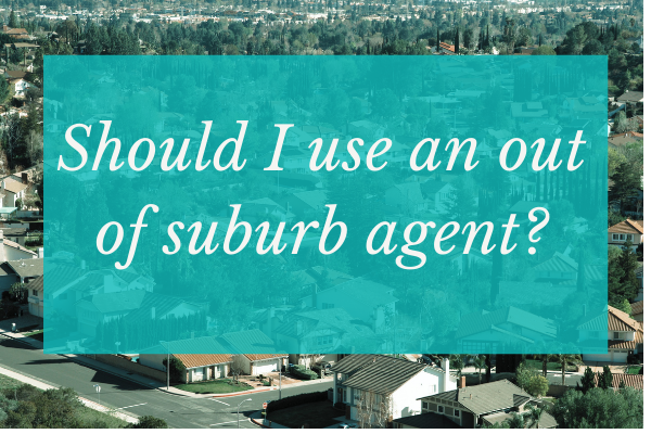 blue box reading 'should I use an out of suburb agent' overlaid against an image of suburban rooftops